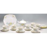 A vintage 1930's Bell china Art Deco tea service decorated with a printed yellow and blue pattern