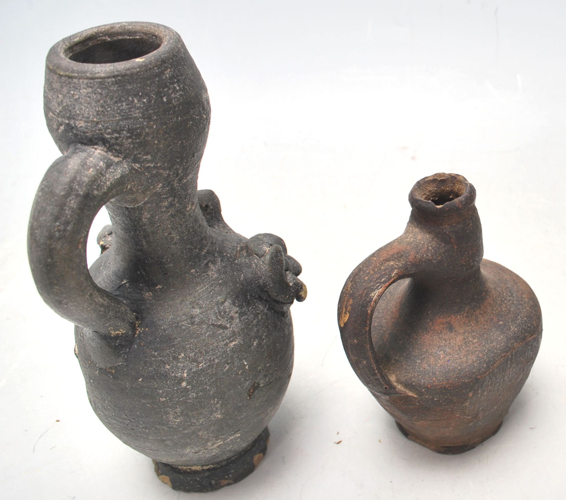 Two antique 16th Century style stoneware hand modelled jugs to to include an oil jug with applied - Image 5 of 7