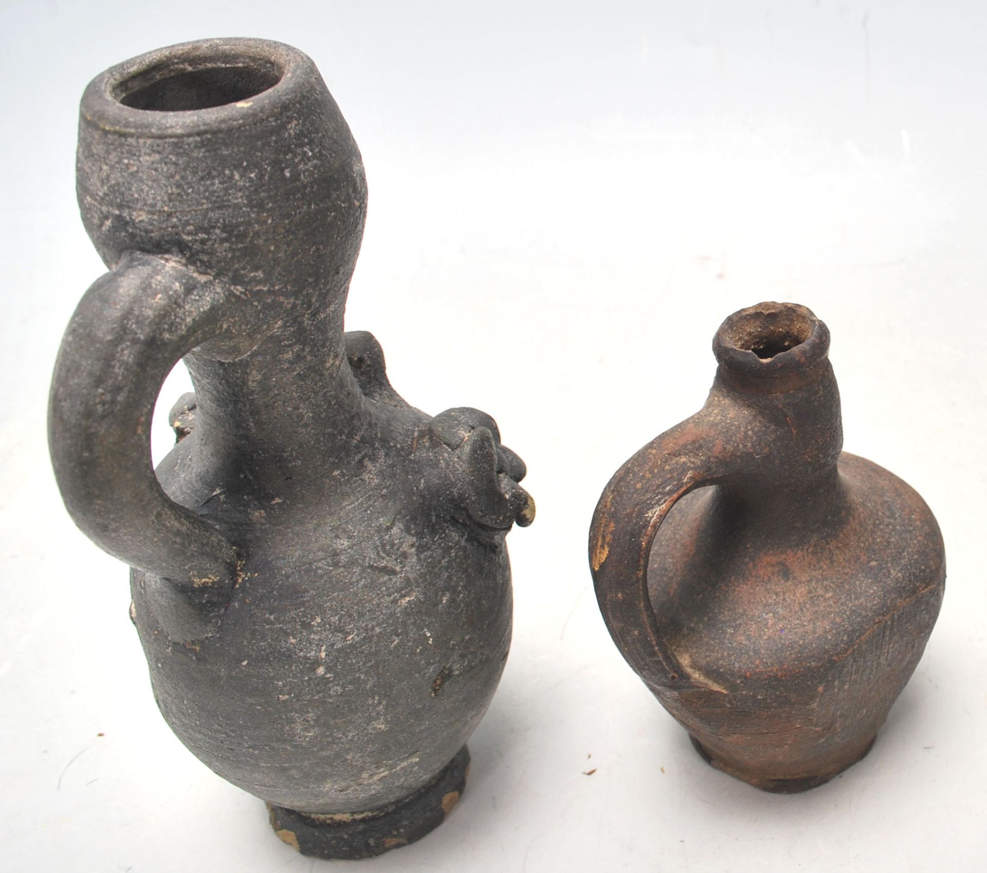 Two antique 16th Century style stoneware hand modelled jugs to to include an oil jug with applied - Bild 5 aus 7