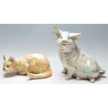 Two 20th Century ceramic large figurines in the form of a pig and a crouching cat each having