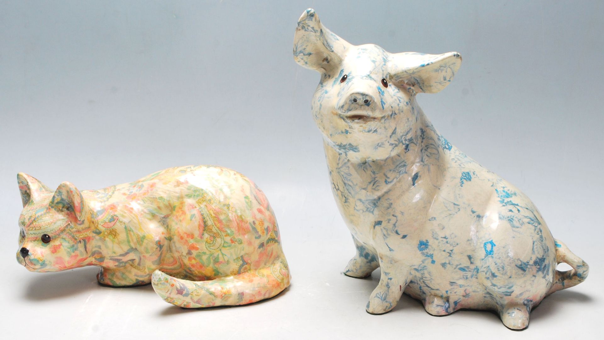 Two 20th Century ceramic large figurines in the form of a pig and a crouching cat each having