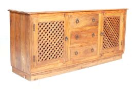 A 20th century Mexican contemporary pine sideboard / dresser base  having a central bank of three