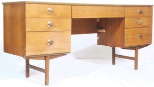 A vintage retro 1970's teak wood kneehole desk / dressing table of Danish influence with central