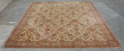 A large early 20th century Persian Islamic rug having red and brown ground with foliate decoration