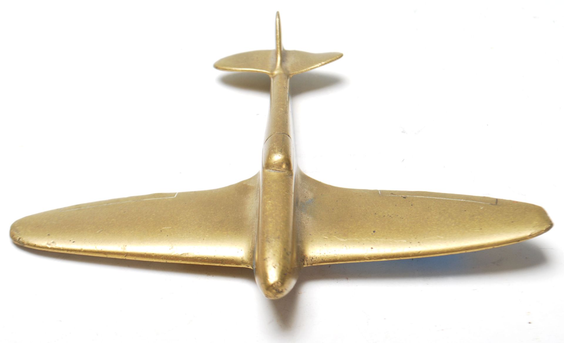 A WWII hand made trench art brass model Spitfire plane. Measures 12.5 x 15cm. Of military interest. - Bild 2 aus 3