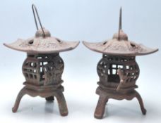 A pair of 20th century cast iron Chinese pagoda lanterns in pumpkin form  having pierced body