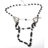 A Swarovski rosary style necklace having spherical ebonised beads on a cable chain with twin glass