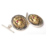 A pair of hallmarked sterling silver two tone cufflinks featuring the iconic Versace style lions