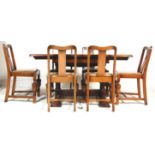 A 1930's Art Deco vintage oak extendable draw leaf dining table and 6 chairs. The table having a