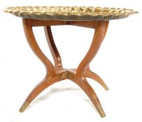 A 20th Century brass tray top opium / binaries occasional table having a brass round tray to the top