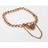 A stamped 9ct gold antique early 20th Century childs curb link bracelet having a heart padlock and