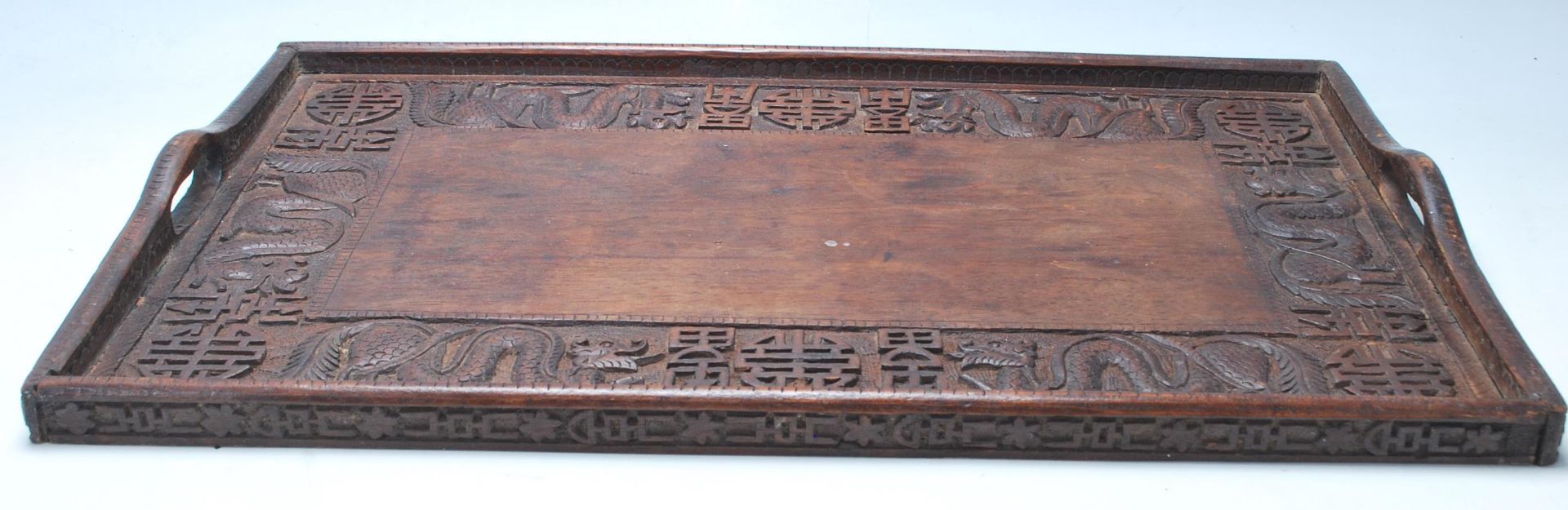 An early 20th Century Chinese Qing Dynasty style carved hardwood rice wine serving tray decorated