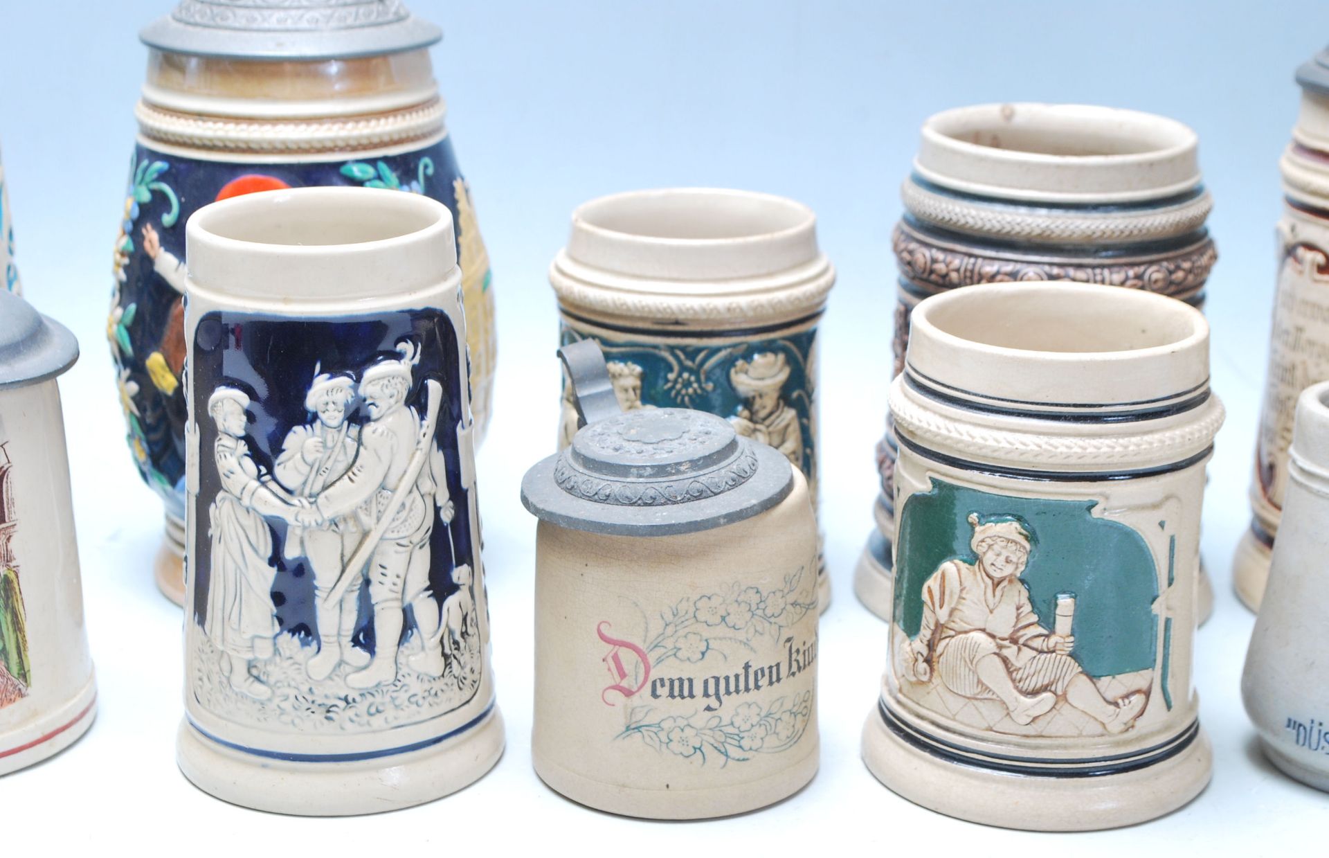 A large collection of German blue and grey stoneware jugs and beer steins, some having pewter - Image 7 of 11