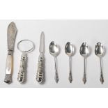 A collection of silver items to include hallmarked silver apostle spoons, a white metal and mother