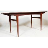 A 1970's retro teak wood Youngers dining table of rectangular form having tapering legs with