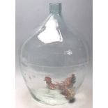 A vintage early 20th century large Indsutrial green glass acid carboy bottle of globular bulbous