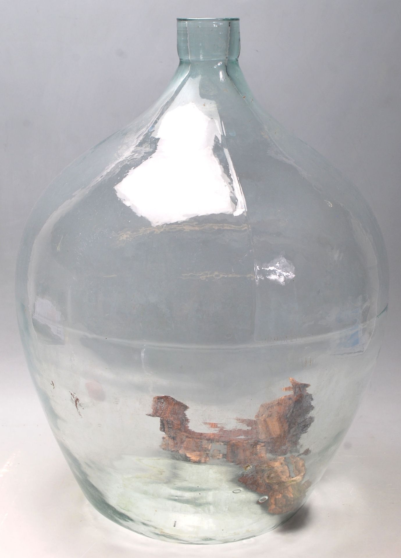 A vintage early 20th century large Indsutrial green glass acid carboy bottle of globular bulbous