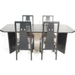 A retro 1980's late 20th century ebonised wooden dining table and 4 dining chairs having a