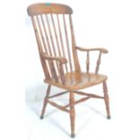 A 19th Century Victorian beech and elm windsor chair  / armchair having a shaped seat raised on four
