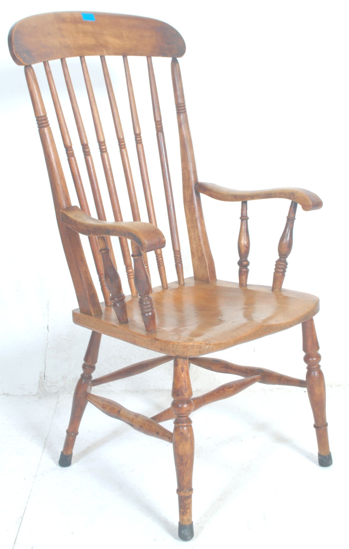 A 19th Century Victorian beech and elm windsor chair  / armchair having a shaped seat raised on four