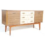 A retro vintage mid century, circa 1950's melamine credenza sideboard having a central bank of three