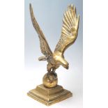 A 20th Century cast brass decorative ornament in the form of an eagle having spread wings raised