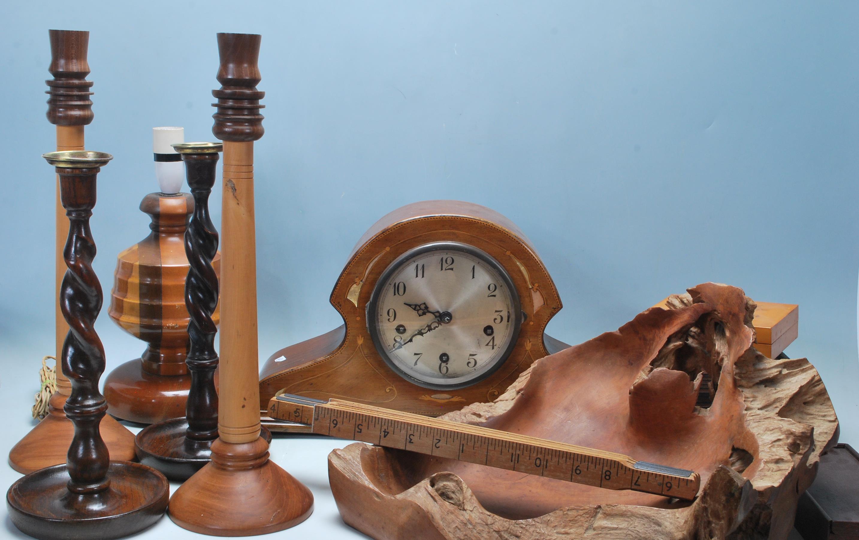 A collection of mid-century woodenware to include a pair of mahogany tall twisted candlesticks,