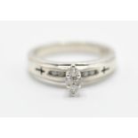 A stamped .925 silver ladies dress ring having a marquise shaped diamond with further diamond accent