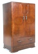 A 1930's Art Deco walnut bachelors wardrobe cabinet having twin panelled doors and a shelved