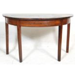 An early 19th century George III mahogany D end / demi-lune side console table having a rounded edge