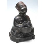 A 20th Century Chinese cast metal censer in the form of a seated man wearing traditional robes and