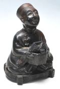 A 20th Century Chinese cast metal censer in the form of a seated man wearing traditional robes and