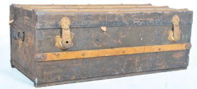 An early 20th century wooden bound steamer trunk with hinged lid, metal locks and banding with