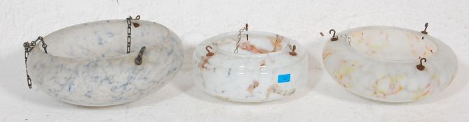 A group of three 1930's Art Deco spatter glass light shades to include a dome shaped shade with blue