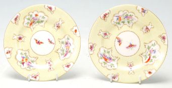 A stunning pair of Royal Worcester hand-painted cabinet plates having gilded edge cartouche with