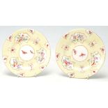 A stunning pair of Royal Worcester hand-painted cabinet plates having gilded edge cartouche with