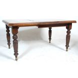 A 19th Century Victorian mahogany extending dining table having  square top with leaf beneath and