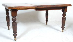 A 19th Century Victorian mahogany extending dining table having  square top with leaf beneath and