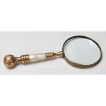 A 20th Century antique style magnifying glass having a brass and mother of pearl handle. 26cm long.