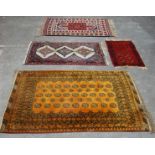 A group of four 20th Century Persian Islamic floor rugs / carpets to include one large yellow ground