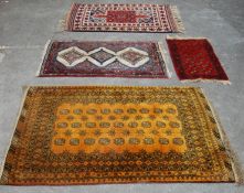 A group of four 20th Century Persian Islamic floor rugs / carpets to include one large yellow ground