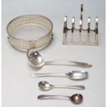 A quantity of early 20th century antique silver items to include a toast rack with hoop handle atop.