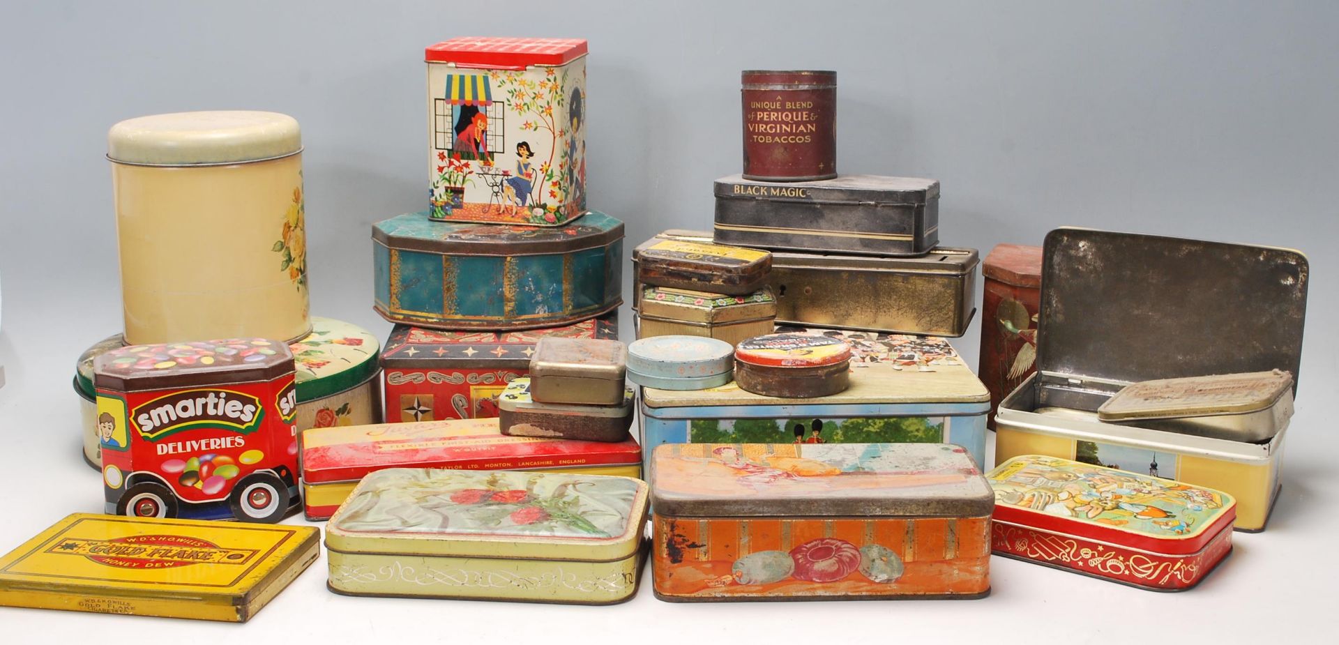 A large collection of vintage mid 20th Century metal advertising tins, biscuits tins, tobaccos