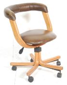 A contemporary modern design desk swivel chair of bentwood beech wood form. The chair having a