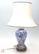 A 20th Century Chinese ceramic blue and white kangxi revival table lamp of baluster form having