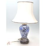 A 20th Century Chinese ceramic blue and white kangxi revival table lamp of baluster form having