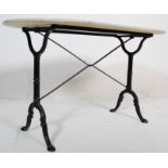 A 20th Century antique style cast iron side / garden table having an oval marble top raised on two