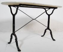 A 20th Century antique style cast iron side / garden table having an oval marble top raised on two