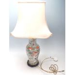 An antique 20th Century Japanese vase / table lamp, having a large cartouche panel at the front