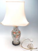 An antique 20th Century Japanese vase / table lamp, having a large cartouche panel at the front